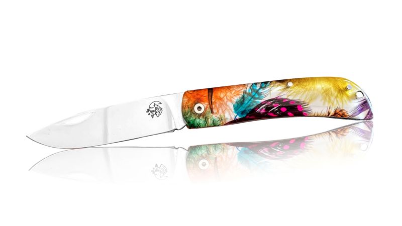 Inclusion of multiple real colored guinea fowl feathers - white background - PMMA resin - made in France